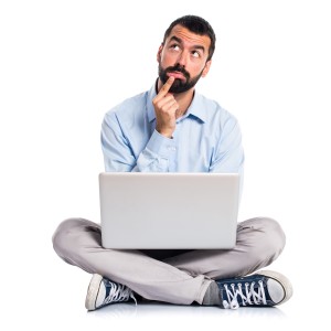 Man with laptop thinking